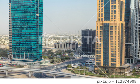 Aerial view of Jumeirah lakes towers skyscrapers timelapse with traffic on sheikh zayed road. Aerial view of Jumeirah lakes towers skyscrapers timelapse with traffic on sheikh zayed road. 112974909