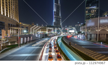 Car traffic on road near mall at night in downtown timelapse hyperlapse. Car traffic on road near mall at night in downtown timelapse hyperlapse. 112974967