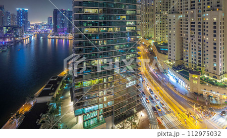 Night illumination of Dubai Marina aerial timelapse, UAE. Night illumination of Dubai Marina aerial timelapse, UAE. 112975032