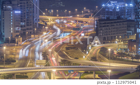 Aerial view of a road intersection in a big city night timelapse. 112975041