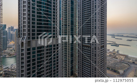 Dubai Marina day to night timelapse, Glittering lights and tallest skyscrapers 112975055
