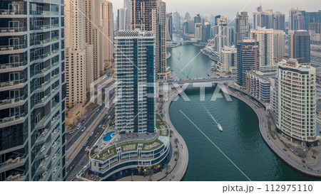 Beautiful aerial top view day to night transition timelapse of Dubai Marina canal 112975110