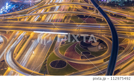 Night traffic on a busy intersection on Sheikh Zayed highway aerial timelapse 112975492