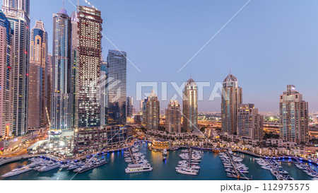 Dubai Marina skyscrapers aerial day to night timelapse, port with luxury yachts and marina promenade Dubai Marina skyscrapers aerial day to night timelapse, port with luxury yachts and marina promenade 112975575