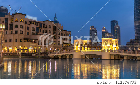 The bridge near the biggest musical fountain in Dubai day to night timelapse. Dubai, UAE 112976733
