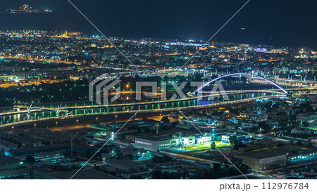 Dubai canal timelapse as seen during night with boats already crossing it. 112976784