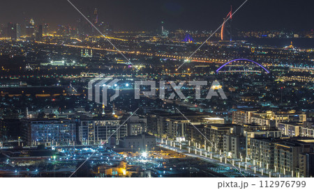 Dubai skyline with Dubai Marina skyscrapers and coastline at dusk timelapse with seven star luxury hotel in Dubai, UAE. 112976799