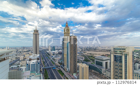 Dubai skyscrapers timelapse evening sunset time. Dubai Metro station and traffic on Sheikh Zayed Road Dubai skyscrapers timelapse evening sunset time. Dubai Metro station and traffic on Sheikh Zayed Road 112976814
