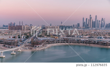 Jumeirah Palm island skyline day to night timelapse in Dubai, UAE. Jumeirah Palm island skyline day to night timelapse in Dubai, UAE. 112976835
