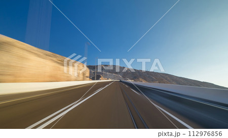 Curvy road through the Jebel Hafeet road timelapse hyperlapse, Al Ain, United Arab Emirates 112976856