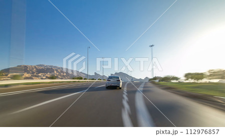 Curvy road through the Jebel Hafeet road timelapse hyperlapse, Al Ain, United Arab Emirates 112976857