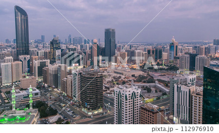 Modern city architecture of Abu Dhabi skyline day to night timelapse, UAE. Modern city architecture of Abu Dhabi skyline day to night timelapse, UAE. 112976910