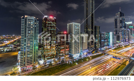 Downtown Dubai towers night timelapse. Aerial view of Sheikh Zayed road with skyscrapers. 112976973
