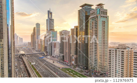 Downtown Dubai towers in the evening timelapse. Aerial view of Sheikh Zayed road with skyscrapers at sunset. 112976975