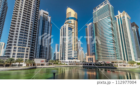 Residential buildings in Jumeirah Lake Towers timelapse hyperlapse in Dubai, UAE. 112977004