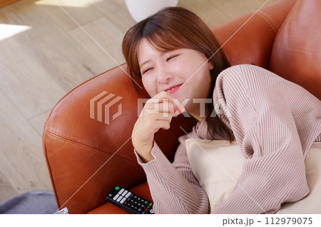 ソファーの上でくつろぐ女性 ソファーの上でくつろぐ女性 112979075