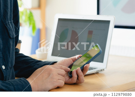 スマホを見る男性 112979880