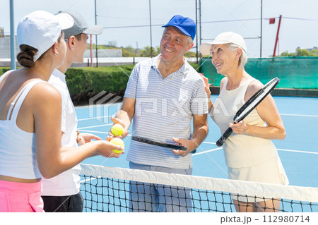 Portrait of smiling tennis team. 112980714