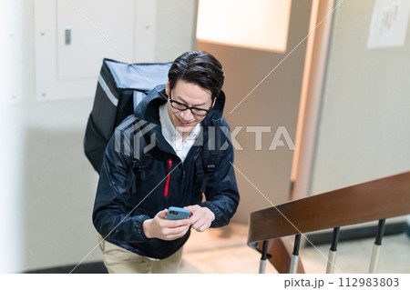 フードデリバリーをする男性 112983803