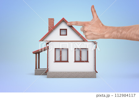 Pointing at a simple depiction of a house Pointing at a simple depiction of a house 112984117