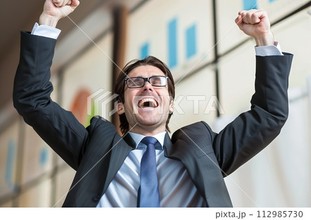 AI-generated content. Exuberant Businessman Celebrating Success 112985730