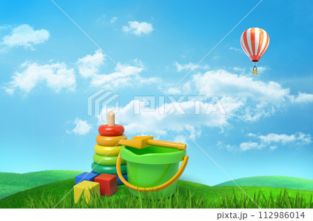 Toys and hot air balloon in a grass field 112986014