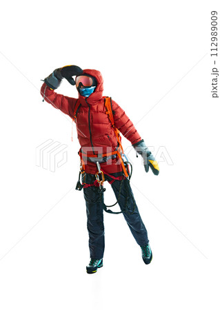 Winter tourism. Man wearing protective goggles, gloves, boots and special equipment for mountain climbing isolated on white background Winter tourism. Man wearing protective goggles, gloves, boots and special equipment for mountain climbing isolated on white background 112989009
