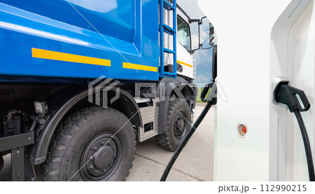 Electric truck batteries are charged from the charging station. Concept.. Electric truck batteries are charged from the charging station. Concept.. 112990215