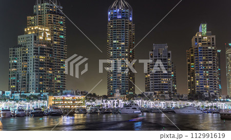 Promenade and canal in Dubai Marina timelapse at night, UAE. Promenade and canal in Dubai Marina timelapse at night, UAE. 112991619