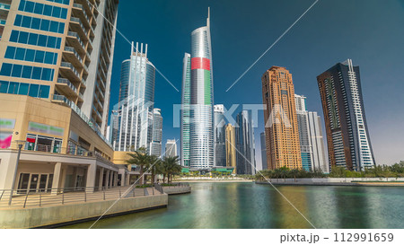 Residential buildings in Jumeirah Lake Towers timelapse hyperlapse in Dubai, UAE. 112991659