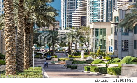 Fountain and palms timelapse at the Marina walk during day time. Dubai, UAE Fountain and palms timelapse at the Marina walk during day time. Dubai, UAE 112991680