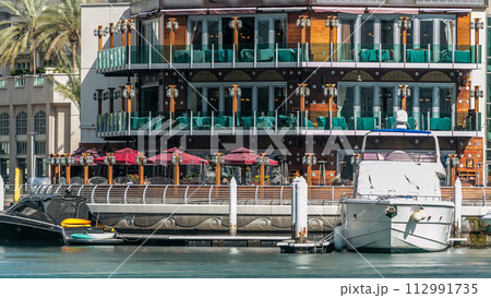 Promenade and restaurants timelapse at the marina walk, During day time. Dubai, UAE Promenade and restaurants timelapse at the marina walk, During day time. Dubai, UAE 112991735