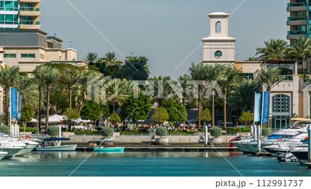 Fountain and palms timelapse at the marina walk, During day time. Dubai, UAE 112991737