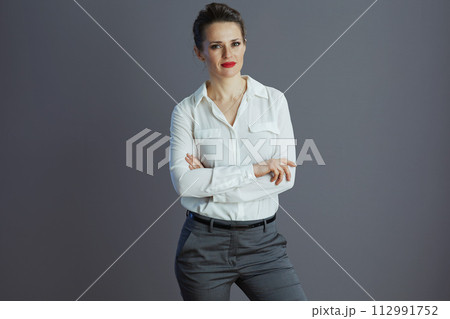 trendy woman worker in white blouse isolated on grey background trendy woman worker in white blouse isolated on grey background 112991752