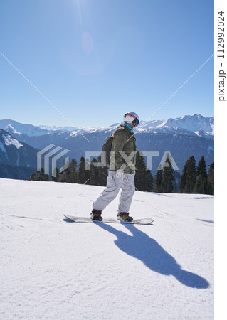 A snowboarder enjoys the descent A snowboarder enjoys the descent 112992024