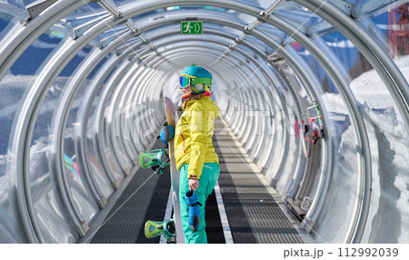 Snowboarder in Mountain Transit Tube Snowboarder in Mountain Transit Tube 112992039