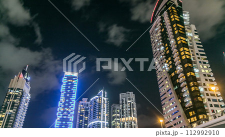 Dubai Marina towers look up view in Dubai night timelapse Dubai Marina towers look up view in Dubai night timelapse 112992910