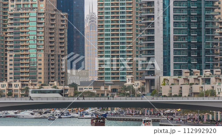 Dubai Marina towers and canal in Dubai day to night timelapse Dubai Marina towers and canal in Dubai day to night timelapse 112992920