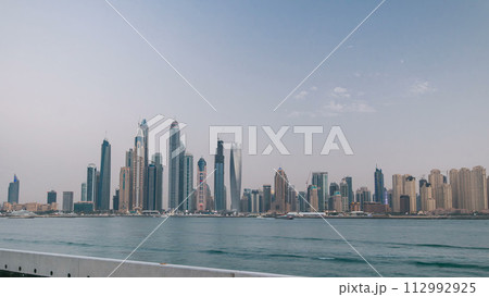 Dubai Marina skyline day to night timelapse as seen from Palm Jumeirah in Dubai, UAE. 112992925