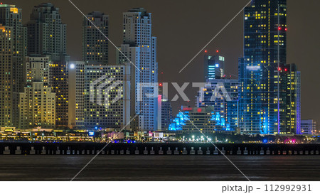 Dubai Marina skyline night timelapse as seen from island in Dubai, UAE. 112992931