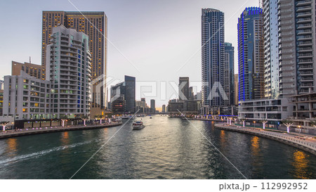 Dubai Marina towers and canal in Dubai day to night timelapse 112992952