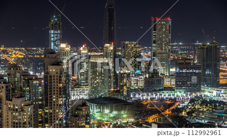 Towers and park near man-made lake timelapse in Dubai downtown, United Arab Emirates. Towers and park near man-made lake timelapse in Dubai downtown, United Arab Emirates. 112992961