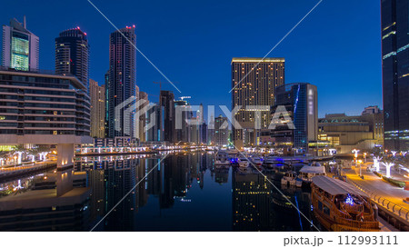 Dubai Marina towers and canal in Dubai night to day timelapse 112993111