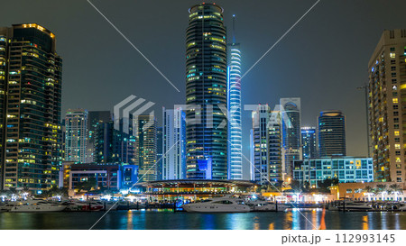 View of Dubai Marina towers and yacht in Dubai at night timelapse hyperlapse 112993145