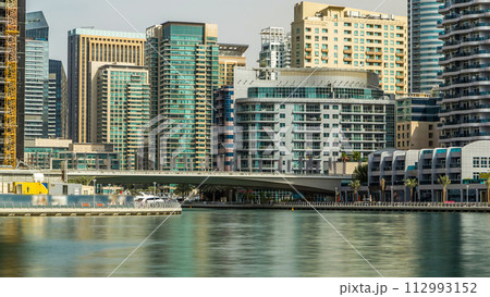 Towers and bridge in Dubai Marina timelapse, UAE. Towers and bridge in Dubai Marina timelapse, UAE. 112993152