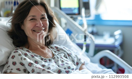 Happy young woman smiling and feeling recovered after getting an emergency surgery at the hospital 112993508