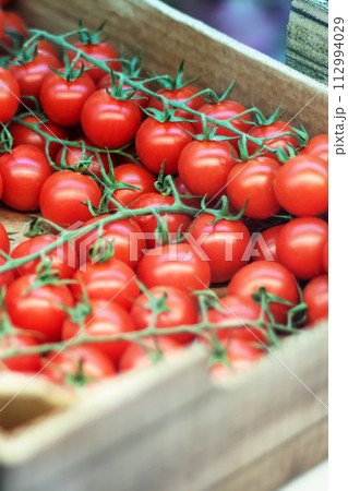 Cherry tomatoes in a wooden container closeup Cherry tomatoes in a wooden container closeup 112994029