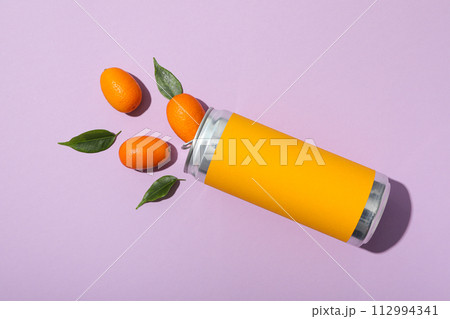 Tin can and kumquats on purple background, top view Tin can and kumquats on purple background, top view 112994341