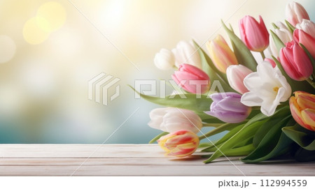 bunch of tulips on wooden table 112994559