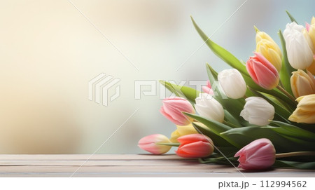 bunch of tulips on wooden table 112994562